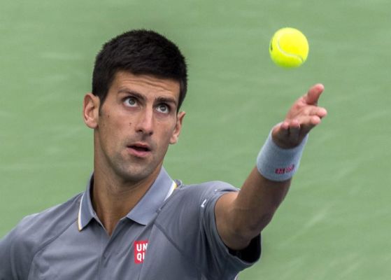 Novak Djokovic of Serbia tosses the ball