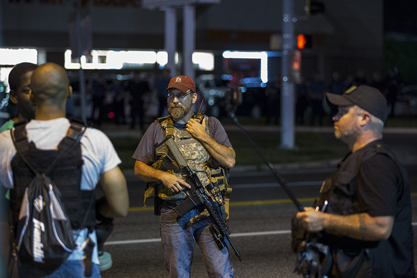 Police in riot gear clashed with protesters who had gathered in the streets of Ferguson early on Tuesday to mark the annivers