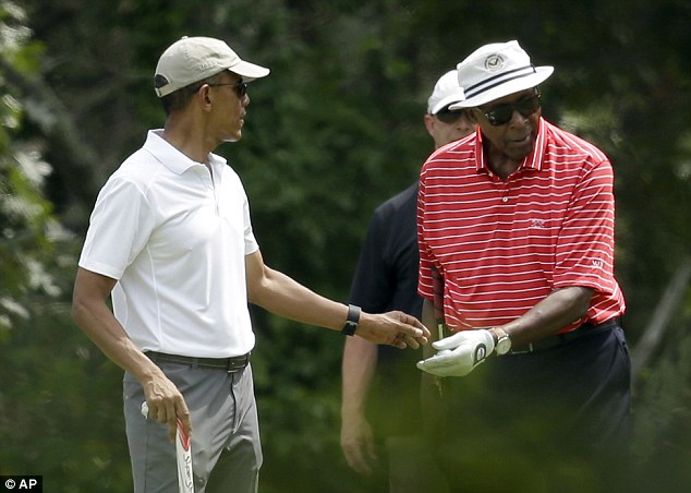 US President Barack Obama walks alongside Cyrus Walker and comedian Larry David as they play golf at Farm Neck Golf Club in Oak Bluffs on Martha's Vineyard in Massachusetts