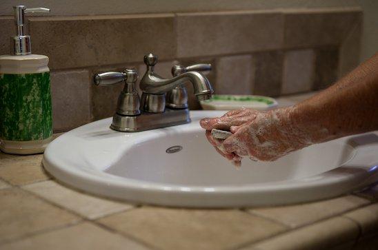 A California resident turns off her faucet while soaping up her hands in order to help save water in Penn Valley Calif