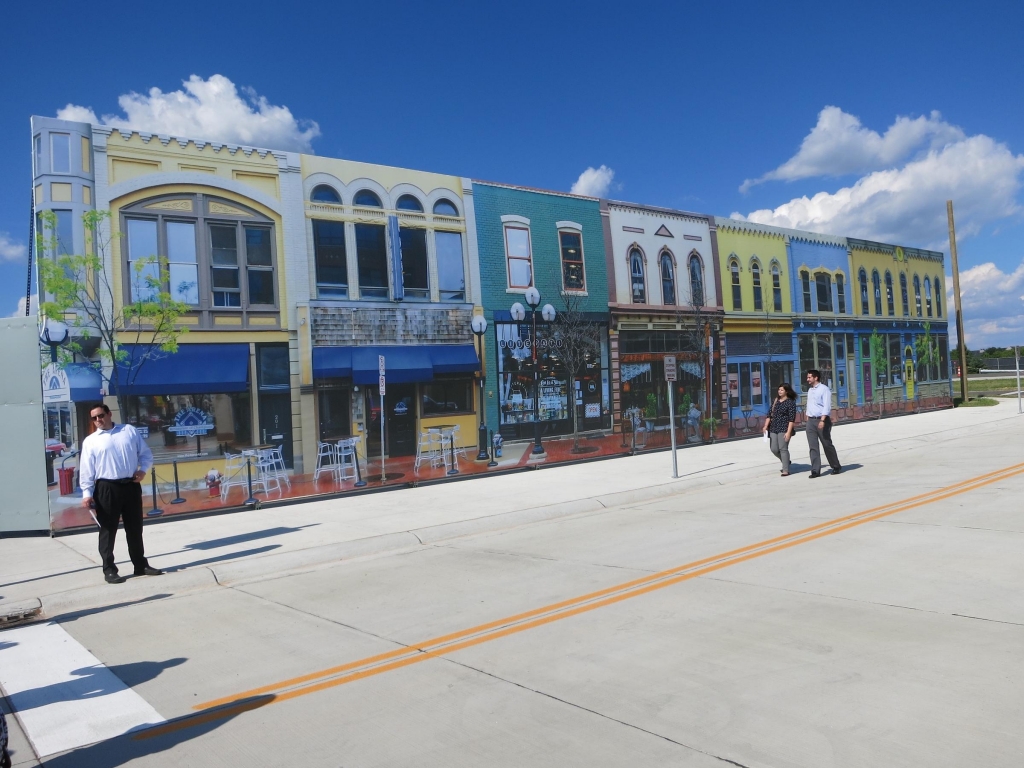 Mcity's'downtown is actually a silk-screen recreation of a street in Ann Arbor Mich. Researchers have built the small fake city at the University of Michigan as a testing ground for autonomous vehicles