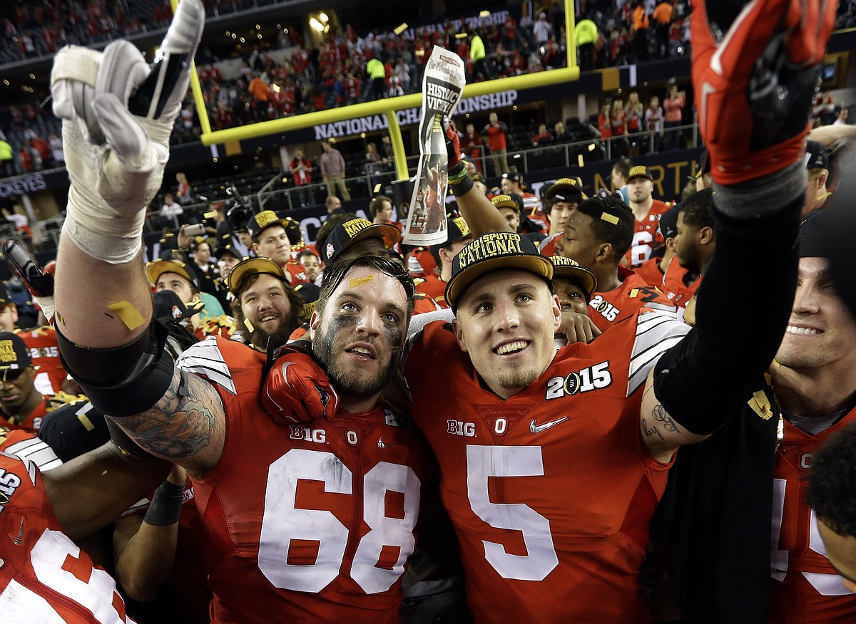 Ohio State's Taylor Decker and Jeff Heuerman celebrate after the NCAA college football playoff championship game against Oregon Monday Jan. 12 2015 in Arlington Texas. Ohio State won 42-20