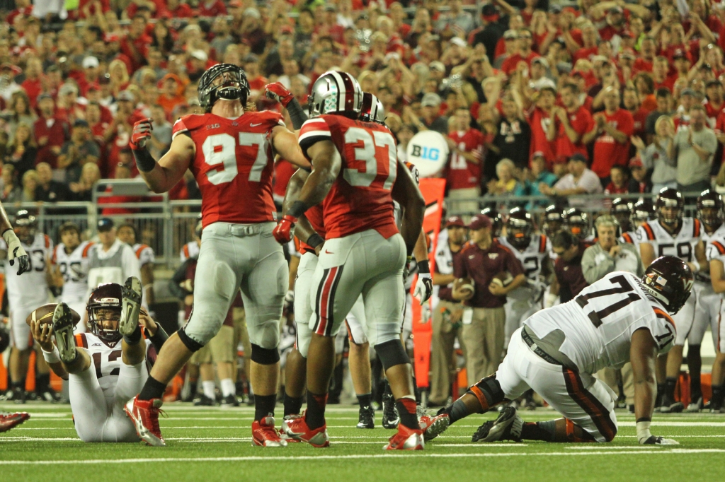 Sophomore defensive lineman Joey Bosa celebrates following a play during a game against Virginia Tech on Sept. 6 at Ohio Stadium. OSU lost 35-21. Credit Mark Batke