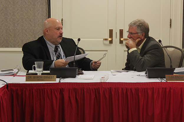 State Board of Education members Byron Ernest and Steven Yager chat during a break at the board's August meeting