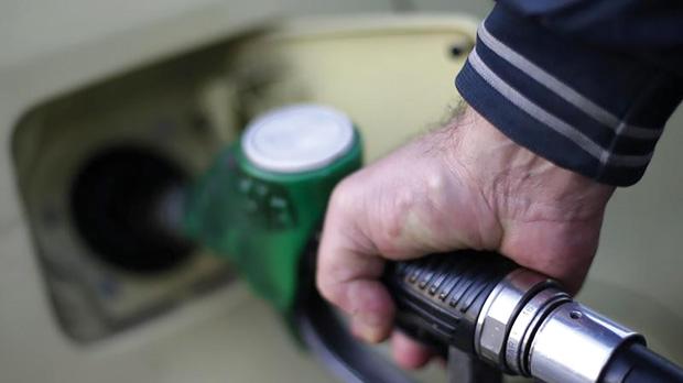 A man filling up his car at a petrol station in Rome