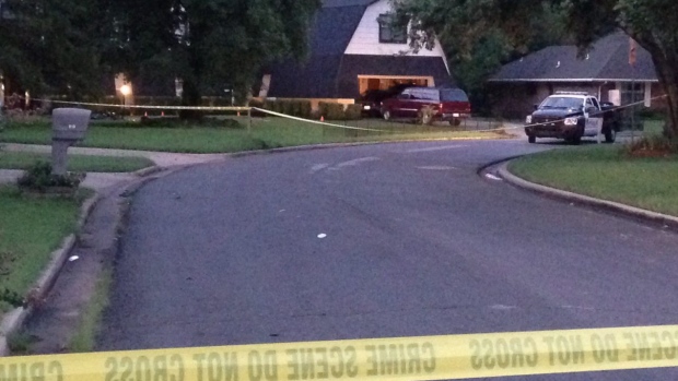 Crime scene tape marks off the area as police investigate Thursday morning in Broken Arrow Okla. where authorities say five people were found dead late Wednesday night