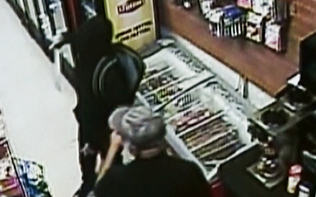 One of the robbers pulls out a machete in the store