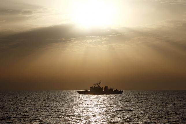 The Italian Coast Guard vessel Michele Fiorillo takes part in a search for missing migrants after their boat capsized off the coast of Libya