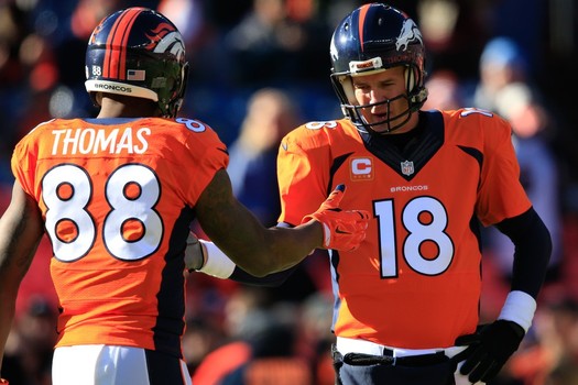 DENVER CO- DECEMBER 28 Quarterback Peyton Manning #18 and wide receiver Demaryius Thomas #88 of the Denver Broncos warm up before a game against the Oakland Raiders at Sports Authority Field at Mile High