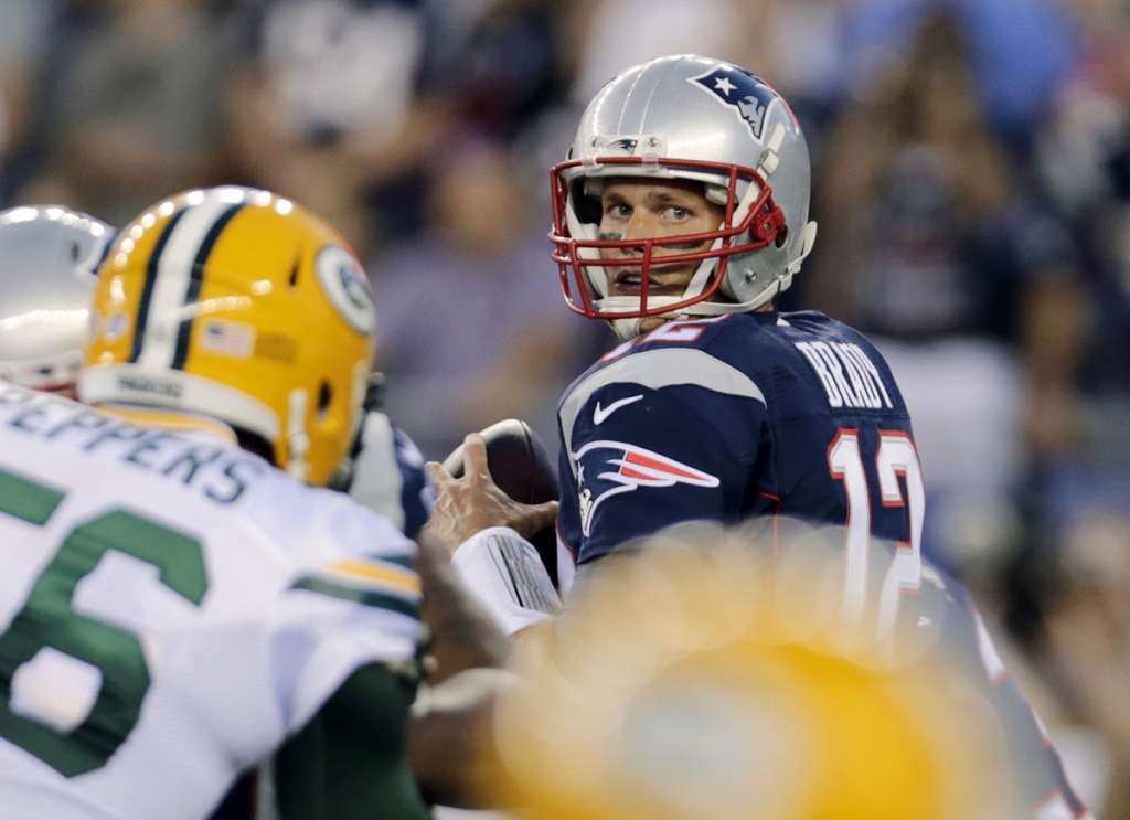 New England Patriots quarterback Tom Brady looks for a receiver during the first half of an NFL preseason football game against the Green Bay Packers