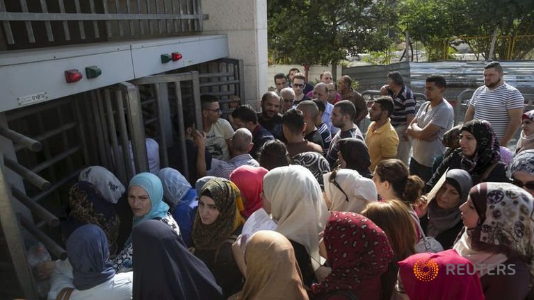 Palestinians queue outside Israel's Interior Ministry office in East Jerusalem