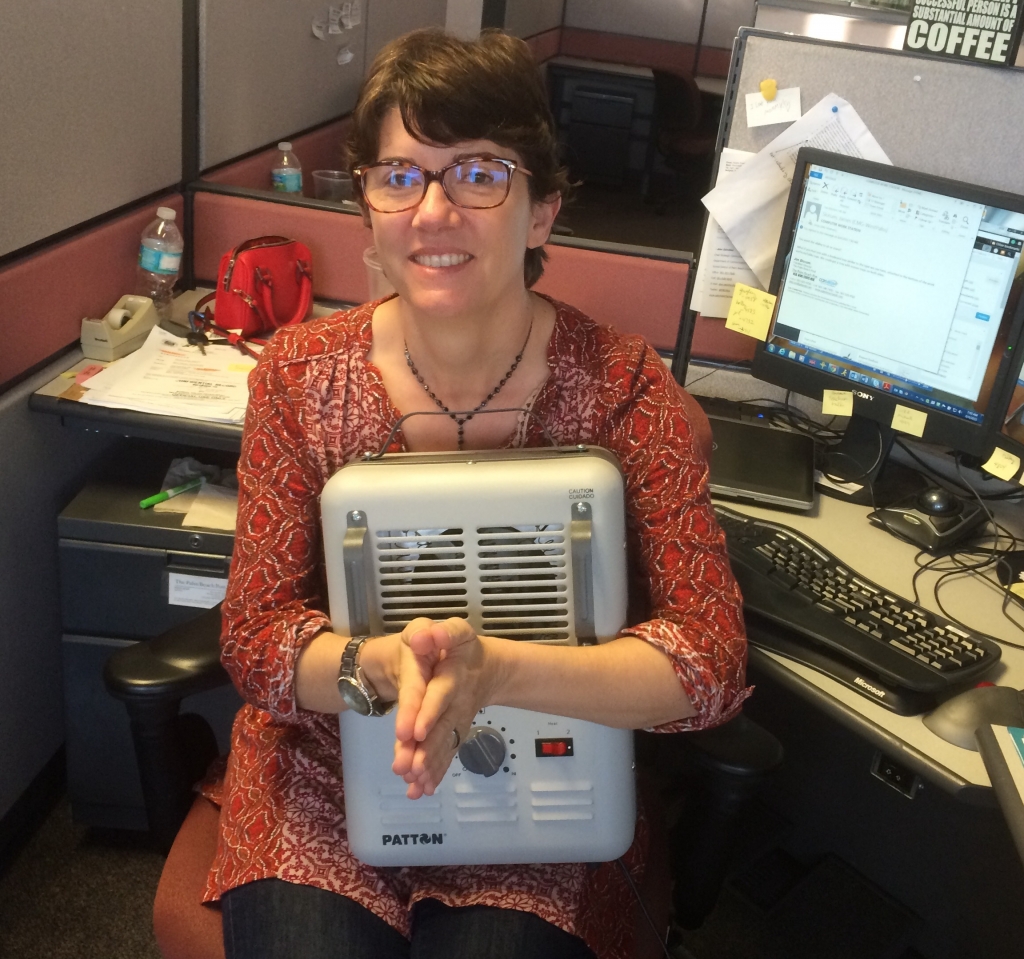 Palm Beach Post education reporter Sonja Isger holds her personal heater