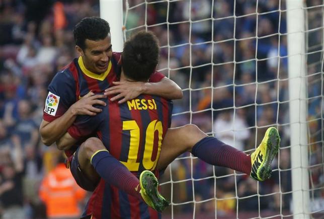 Pedro is carried by Barca teammate Lionel Messi