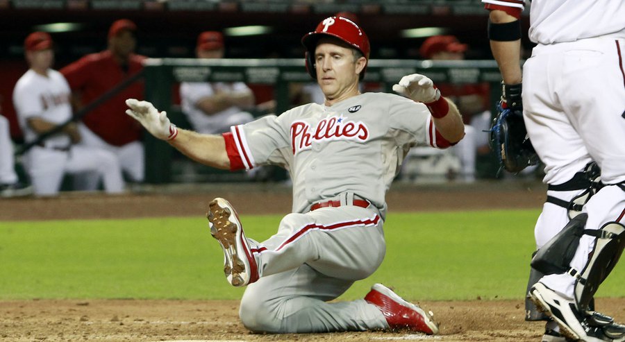 Philadelphia Phillies&#39 Chase Utley left slides home to score a run against Arizona Diamondbacks on an RBI double by teammate Cesar Hernandez during the fifth inning of a baseball game Monday Aug. 10 2015 in Phoenix