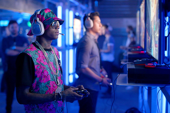 Rapper Soulja Boy tries the Xbox One during the E3 Showcase party