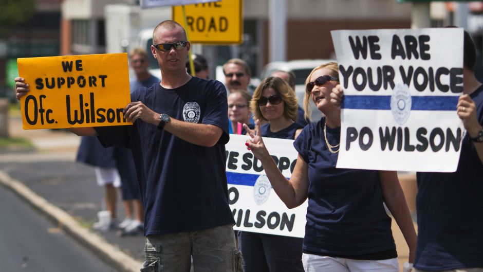 Supporters of Ferguson Police Officer Darren Wilson hold signs in protest