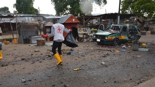 A red cross official walks at the site of a bomb explosion in Maiduguri Nigeria. |AP