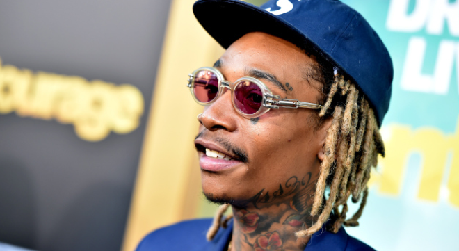 Rapper Wiz Khalifa handcuffed and pinned to the ground for riding a hoverboard