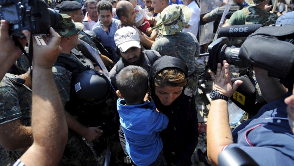 Police allow people to trickle through the Macedonia Greece border Aug 24 2015