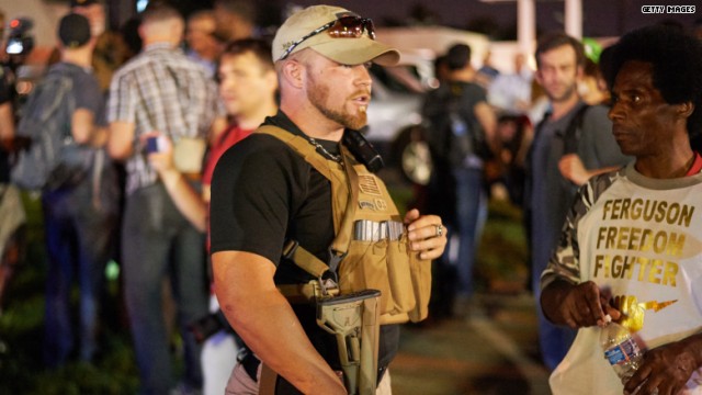 Officers and protesters face off along West Florissant Avenue on Monday night in Ferguson Missouri. Ferguson was a community on edge again Monday a day after a protest marking the anniversary of Michael Brown’s death was punctuated with gunshots. (Jef