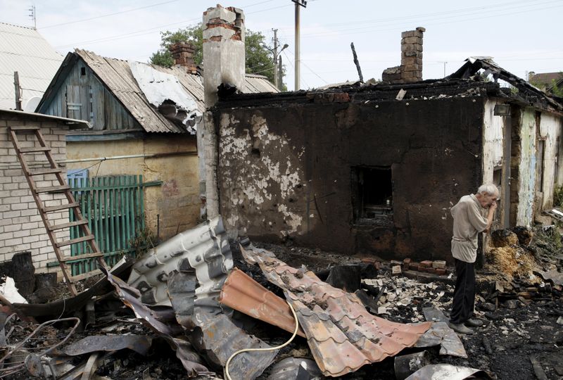 A man cries as he inspects debris while standing outside his damaged house caused by recent shelling in Donetsk Ukraine. – Reuters pic