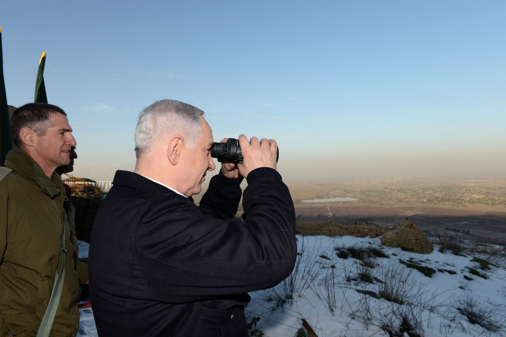 Prime Minister Benjamin Netanyahu looks into Syria from the Golan Heights in January 2013