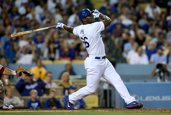 LOS ANGELES CA- AUGUST 11 Yasiel Puig #66 of the Los Angeles Dodgers hits a triple with the bases loaded in the fifth inning against the Washington Nationals at Dodger Stadium