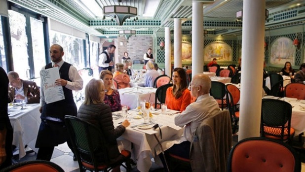 Quests sit for a tasting in the main dining room of Brennan's Restaurant a historic restaurant in the French Quarter in New Orleans