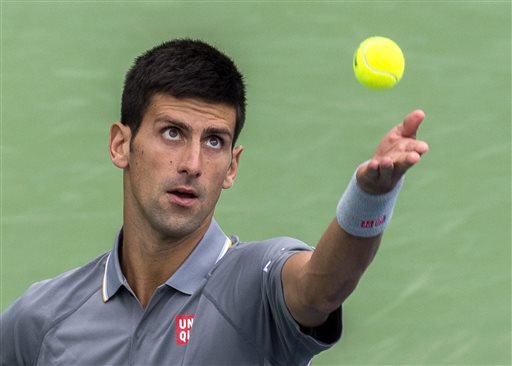 Novak Djokovic of Serbia tosses the ball to serve to Jack Sock of the United States during the Rogers Cup men's tennis tournament in Montreal Thursday Aug. 13 2015. MANDATORY CREDIT