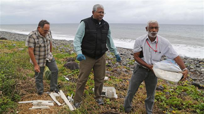 A Malaysian expert looks for debris from the ill-fated Malaysia Airlines flight MH370 on the French Reunion Island in the Indian Ocean