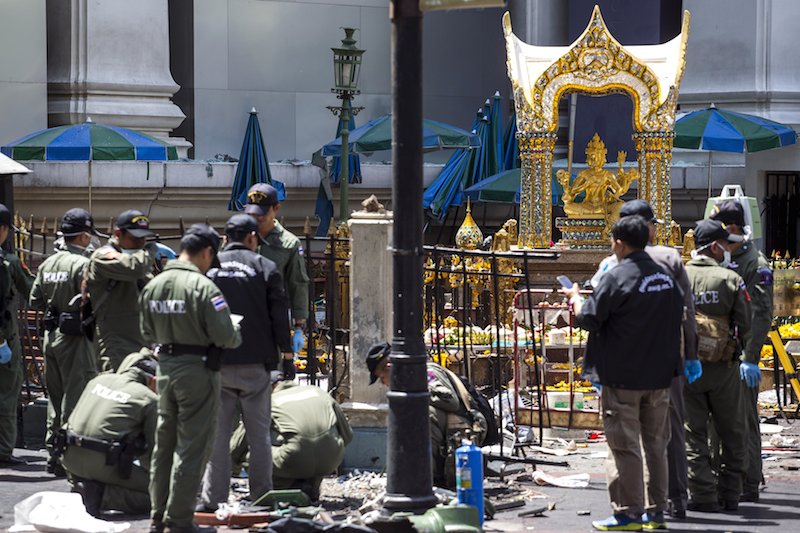 Experts investigate the Erawan shrine at the site of a deadly blast in central Bangkok Thailand today. Two Malaysians killed in the blast have been identified as Lim Saw Gek and her son Neoh Jai Jun. – Reuters pic