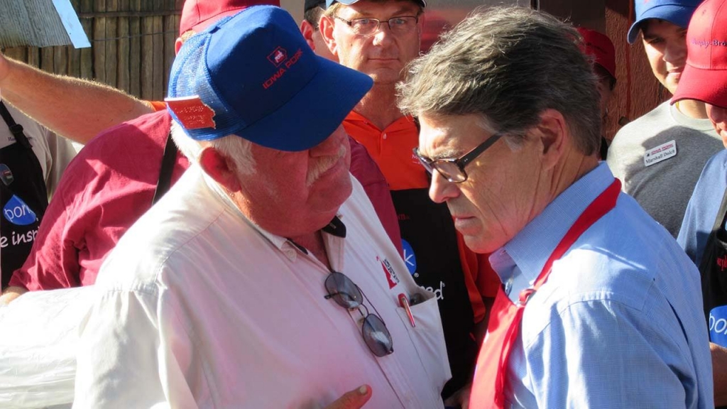 Rick Perry listens to a person at the Iowa State Fair