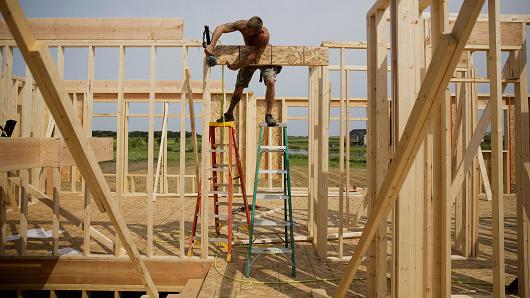 A contractor installs a door header inside a house under construction for Ironwood Homes in Peoria Illinois