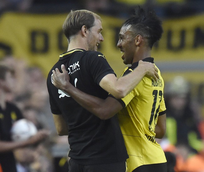 Dortmund head coach Thomas Tuchel embraces Dortmund's scorer Pierre Emerick Aubameyang during the German Bundesliga soccer match between Borussia Dortmund and Borussia Moenchengladbach in Dortmund Germany