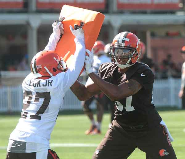 Robert Nelson Jr holds a blocking pad as Terrelle Pryor moves him away during a drill at camp on July 31. BRUCE BISHOP  CHRONICLE