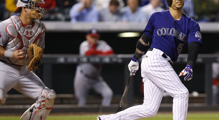 Colorado Rockies&#39 Carlos Gonzalez right reacts after striking out in front of Washington Nationals catcher Wilson Ramos during the fifth inning of a baseball game Tuesday Aug. 18 2015 in Denver