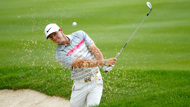 Rory Mc Ilroy of Northern Ireland hits out of a bunker onto the eighth green during the final round of the World Golf Championships Bridgestone Invitational