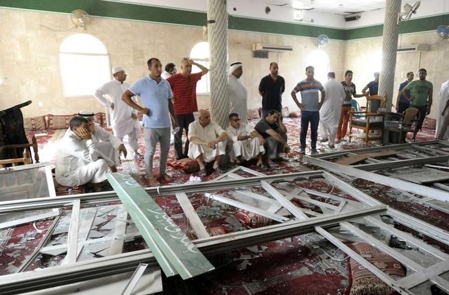 Saudi men gather around debris following a blast inside the Shiite mosque in Qatif eastern Saudi Arabia earlier this year