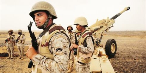 Saudi troops stand ready to fire live projectile rounds into Yemen from positions inside Saudi territory