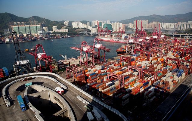 Shipping containers sit stacked among gantry cranes at the Kwai Tsing Container Terminals in Hong Kong China