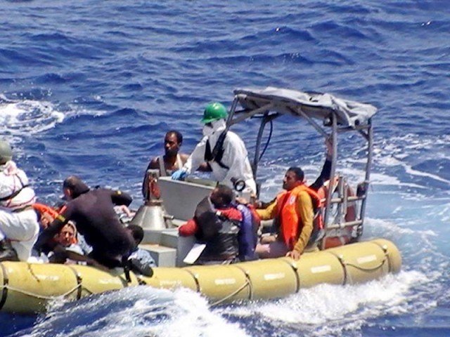 Crew of the Italian Navy destroyer Mimbelli rescuing survivors at the site where a boat carrying over 600 migrants capsized in the Mediterranean off the Libyan coast