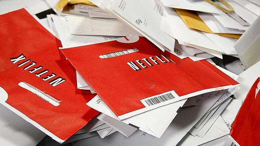 Red Netflix envelopes sit in a mail bin at the U.S. Post Office sort center