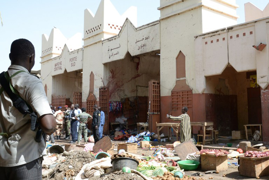 Soldiers and police forces stand guard at a market in N'Djamena following a suicide bomb attack