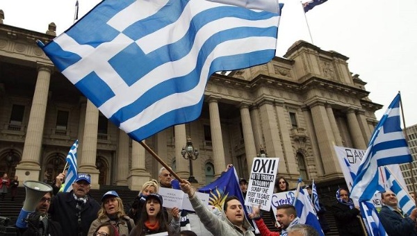 Solidarity protesters in Australia fly the Greek flag shouting'No in support of Greece