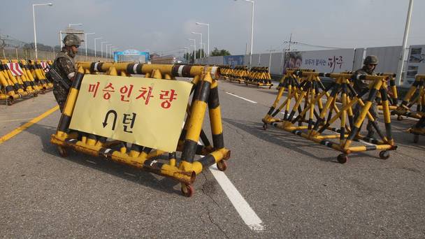 South Korean army soldiers adjust barricades set up on Unification Bridge which leads to the demilitarised zone in Paju