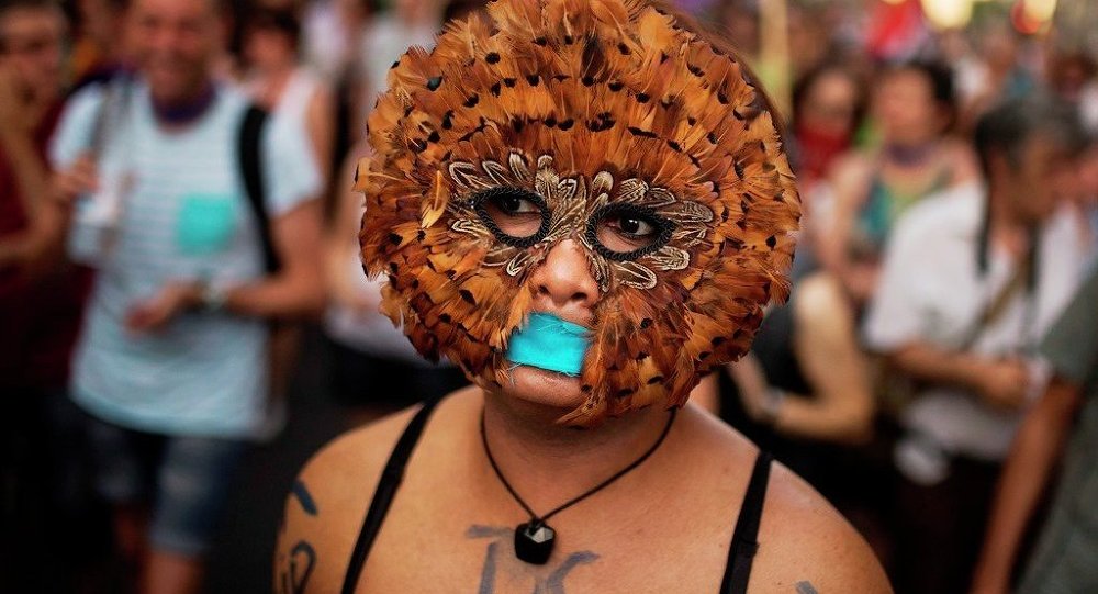 A protester takes part in a march against the Public Security Law gag law in Madrid Spain Tuesday