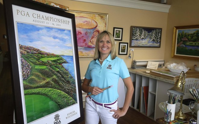 Cassy Tully artist and owner of Cassy Tully Fine Art in Plymouth poses in her with the official PGA Championship lithograph she created and will sell at the event