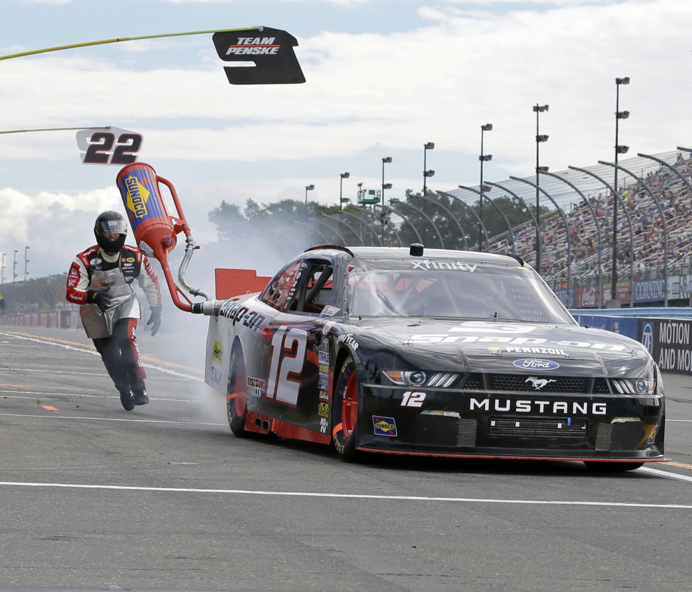 Joey Logano leaves the pits with a gas can stuck to his car during the Xfinity Series race Saturday at Watkins Glen International. Logano was penalized for the incident but rallied to win the race