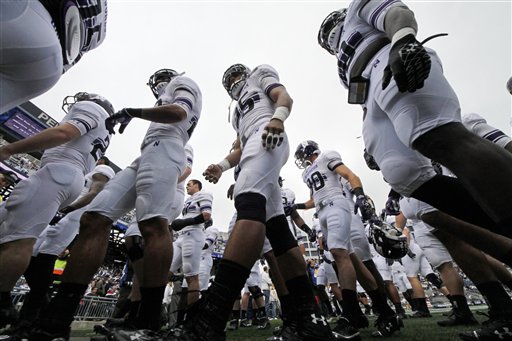 The Northwestern football team heads to the locker room after warming up before a game against Penn State in this 2012