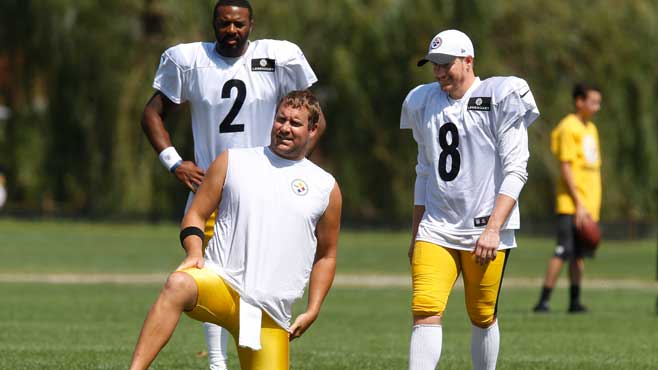 Pittsburgh Steelers quarterback Ben Roethlisberger takes a knee in front of newly-acquired place kicker Garrett Hartley as they go through holding drills during NFL football training camp in Latrobe Pa. Tuesday Aug. 11 2015. (AP